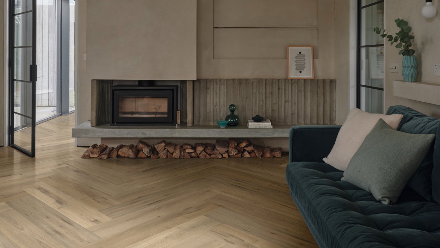 Leyster Oak lvp floors in a herringbone pattern direct the focus to the fireplace