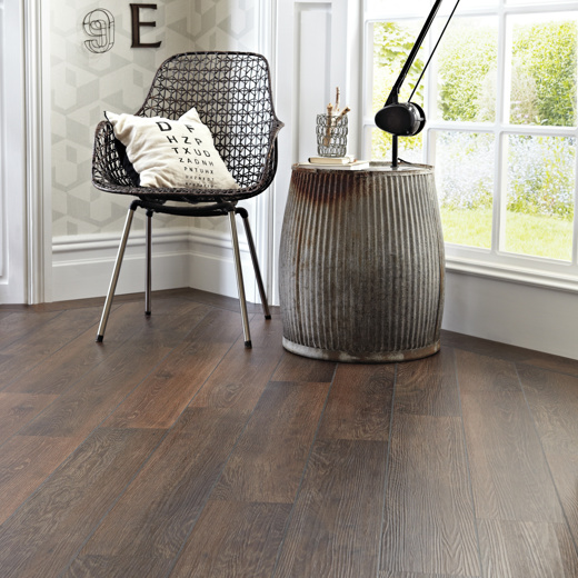 Photo of KP98 Aged Oak dark brown LVT flooring in a home by a window